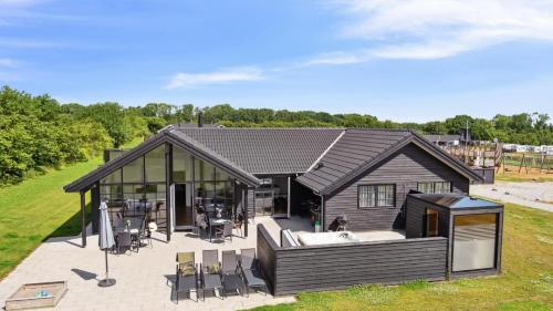 a large house with a hot tub in the backyard at Villavilla 520 - Mommark, Sydjylland in Sarup