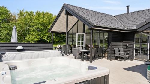 a hot tub on the patio of a house at Villavilla 520 - Mommark, Sydjylland in Sarup