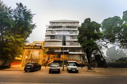 a building with cars parked in front of it at Treebo Premium Landmark Prayagraj in Prayagraj
