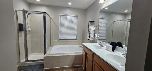 a bathroom with a tub and a sink and a shower at Townhome in Ranson, WV in Ranson