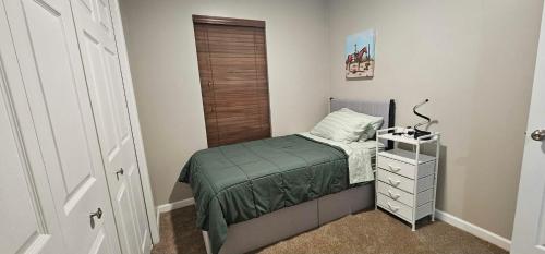 a small bedroom with a small bed and a dresser at Townhome in Ranson, WV in Ranson