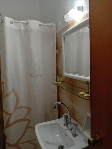 a bathroom with a sink and a shower curtain at Amaryllis Hotel in Karpathos