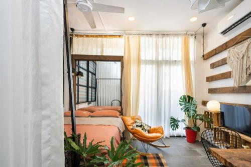 a bedroom with a bed and a chair and a window at StayX Central Suites Q1 in Ho Chi Minh City