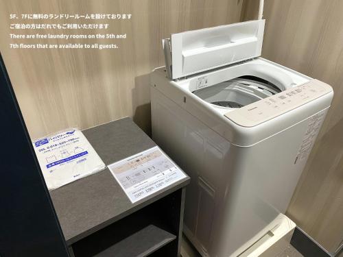 a washer and dryer in a small room at EISEI STAY Ikebukuro Nishi in Tokyo