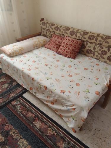 a bed sitting on top of a couch in a room at غرفة هادئة للإيجار باليوم in Alexandria