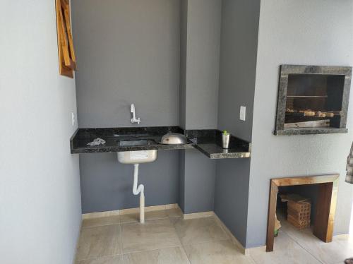 a bathroom with a sink and a mirror on the wall at House with pool Arroio do Sal in Arroio do Sal
