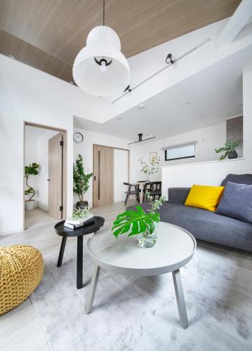 a living room with a couch and a table at ぷふか東向島 in Tokyo