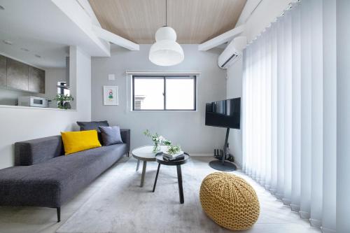 a living room with a couch and a table at ぷふか東向島 in Tokyo