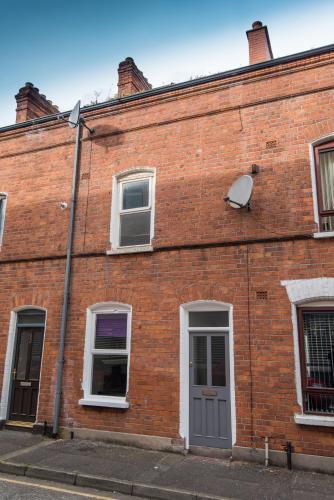 a red brick building with a satellite at Big Fish - Charles St South in Belfast