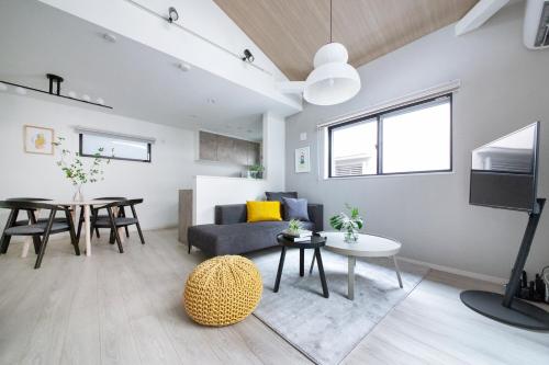 a living room with a couch and a table at ぷふか東向島 in Tokyo
