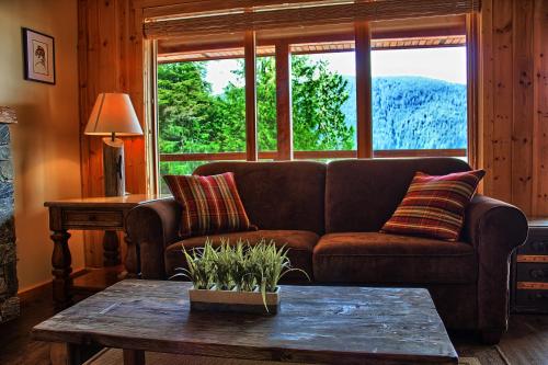 a living room with a couch and a table at Wild Renfrew Seaside Cottages in Port Renfrew