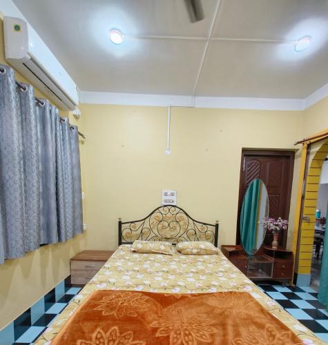 a bedroom with a large bed in a room at Anjali Homestay - 10 mins from Bagdogra airport in Siliguri