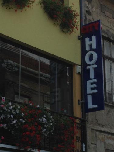 a hotel sign on the side of a building at Heartland City B&B in Tuzla