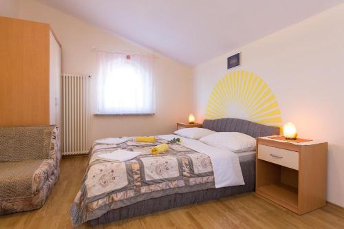 a bedroom with a bed and a couch at Apartments Juras in Brzac