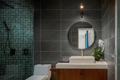 a bathroom with a sink and a mirror at Lomhae Kirirom Resort by EHM in Phumĭ Péam Lvéa