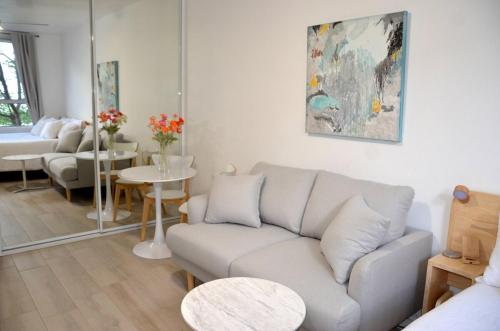 a living room with a couch and a table at Cute Studio Apartment in Maroubra in Sydney