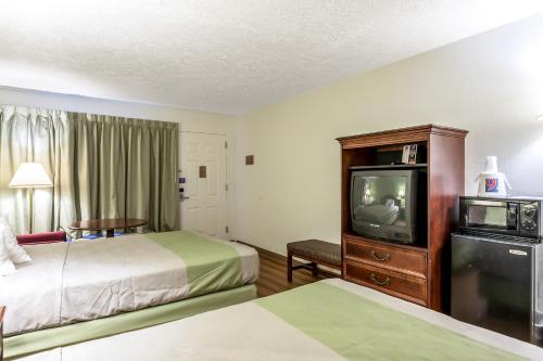 a hotel room with two beds and a tv at Americas Best Value Inn Edgewood, MD in Edgewood