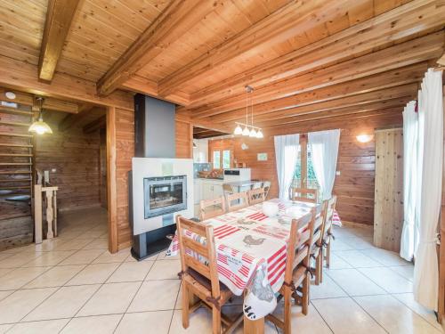 a dining room with a table and a kitchen at Chalet in Vosges with Sauna & Panoramic Views in Anould