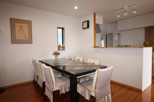a dining room with a table and chairs at Tomi house in Kariya