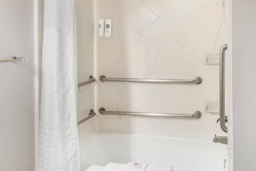 a bathroom with a shower with a white shower curtain at Comfort Inn & Suites El Paso I-10 Airport Area in El Paso