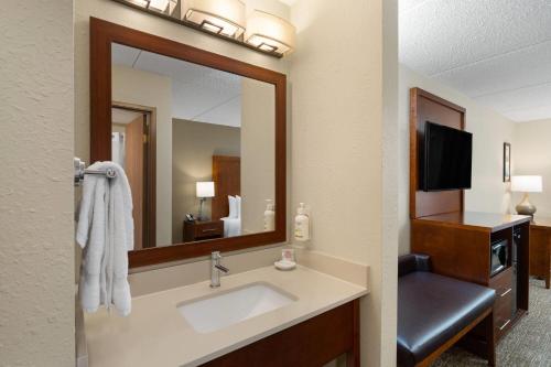 a bathroom with a sink and a mirror at Wingate by Wyndham Clearfield in Clearfield