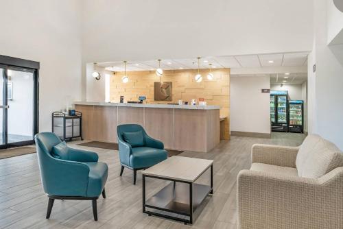 a waiting room with two chairs and a table at Comfort Inn & Suites Madison East Interstate I-90 in Madison