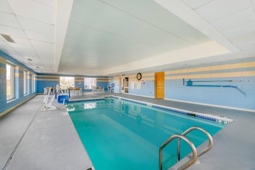 a large swimming pool in a building at Comfort Inn & Suites Madison East Interstate I-90 in Madison