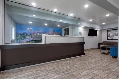a waiting room with a view of a city at Super 8 by Wyndham Fort Worth Entertainment District in Fort Worth