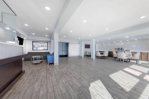 an empty office with a large room with tables and chairs at Super 8 by Wyndham Fort Worth Entertainment District in Fort Worth