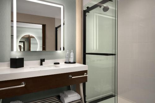 a bathroom with a sink and a shower at Tempo By Hilton Pigeon Forge in Pigeon Forge