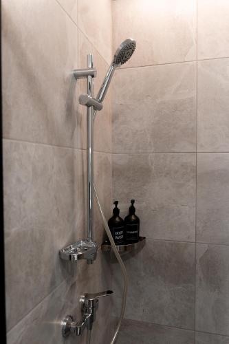 a shower with a shower head in a bathroom at Hotel Palace Ukraine in Mykolaiv