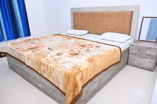 a bedroom with a large bed in a room at Nirmala Garden in Bamiana