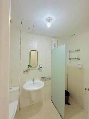 a bathroom with a sink and a toilet and a mirror at STUDIO WITH BALCONY at the HEART of DAVAO CITY in Davao City