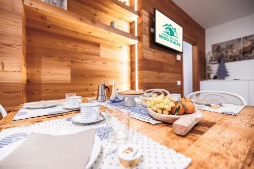a dining room table with a blue and white table cloth at CHALET GIOVANNI apricacasevacanze in Aprica