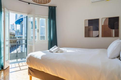 a bedroom with a large white bed and a balcony at Bluewood Retreat|Cozy Vintage 3BDR Nicosia Heart in Nicosia