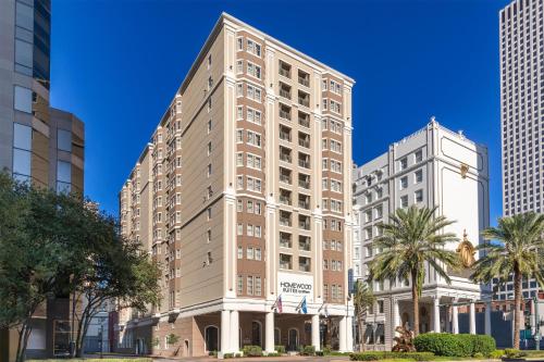 a tall building with palm trees and buildings at Homewood Suites by Hilton New Orleans in New Orleans