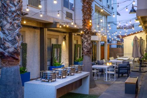 a restaurant with tables and chairs and lights at DoubleTree by Hilton Campbell - Pruneyard Plaza in Campbell