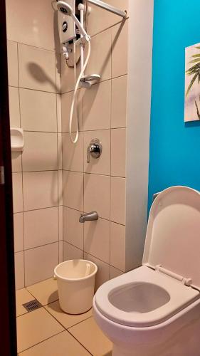 a bathroom with a toilet and a shower at Horizons 101 Cebu- Premium Studio in Cebu City