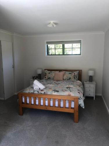 a bedroom with a bed and a window at The Cottage in Waikawa in Waikawa
