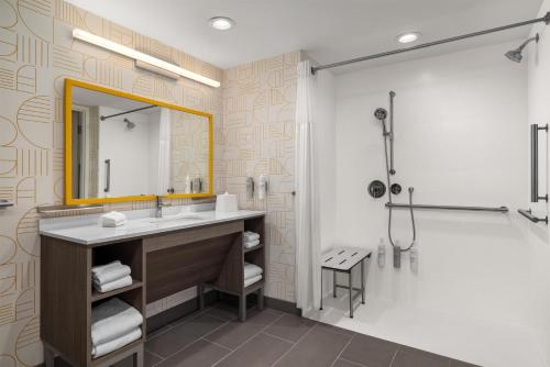 a bathroom with a sink and a shower at Home2 Suites By Hilton Muncie in Muncie