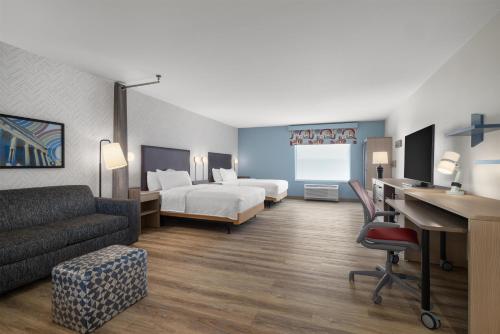 a hotel room with a bed and a desk at Home2 Suites By Hilton Muncie in Muncie