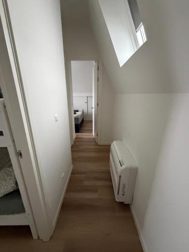 a room with a staircase with a bed and a window at Apartement hotel Stays by ADM in Leiden