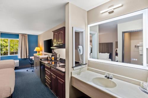 a bathroom with a sink and a large mirror at Quality Inn Port Orchard in Port Orchard