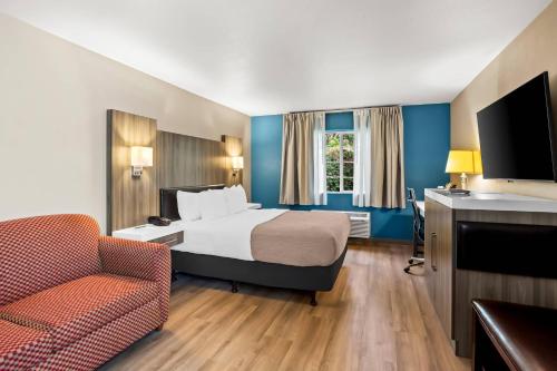 a hotel room with a bed and a chair at Quality Inn Port Orchard in Port Orchard