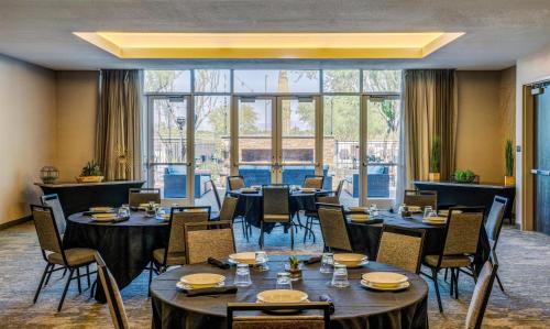 a restaurant with tables and chairs and a large window at Hilton Garden Inn North Phoenix Scottsdale in Phoenix