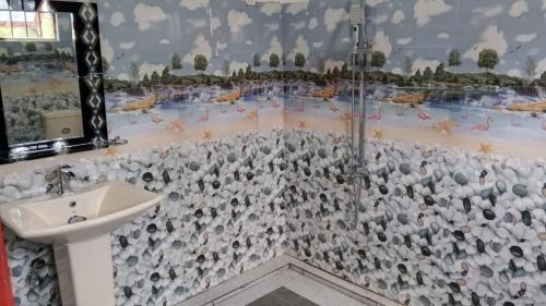a bathroom with a shower and a sink at Villa Rashel in Nikawatawana