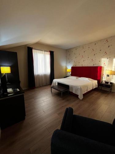 a hotel room with a bed and a couch at Hotel Fortyfive in Chivasso