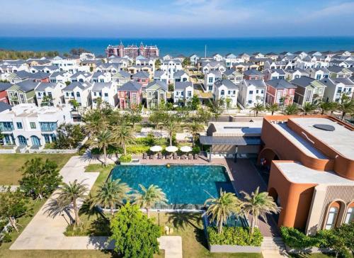an aerial view of a resort with a swimming pool and houses at Sunset Villa - Novaworld Phan Thiết in Bình Tú