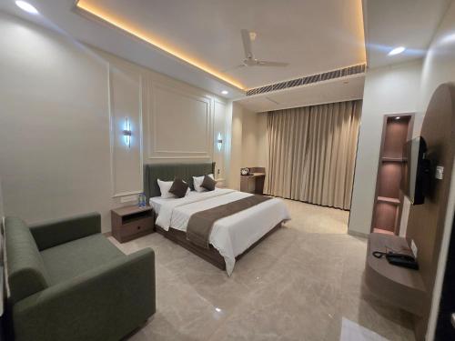 a hotel room with a bed and a couch at Hotel Shree Karni Palace in Kishangarh