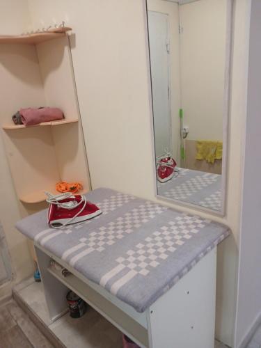 a mirror sitting on top of a bed in a room at LIBERTY Hostel in Mykolaiv